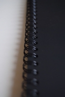 A black spring holds the pages of the album