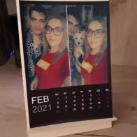 Calendar with photos on a wooden desktop stand