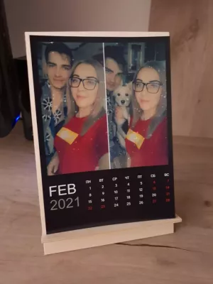 Calendar with photos on a wooden desktop stand